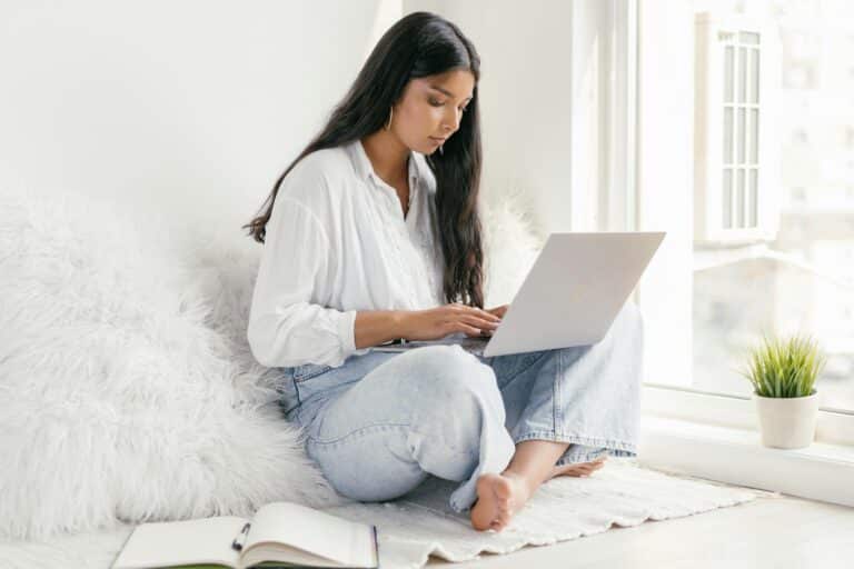 Woman working on laptop at home.