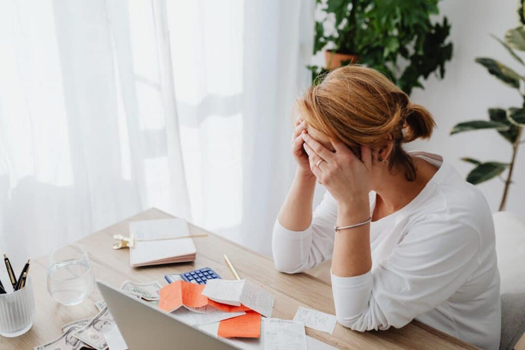 Stress & Money Management with money, woman with hands over face