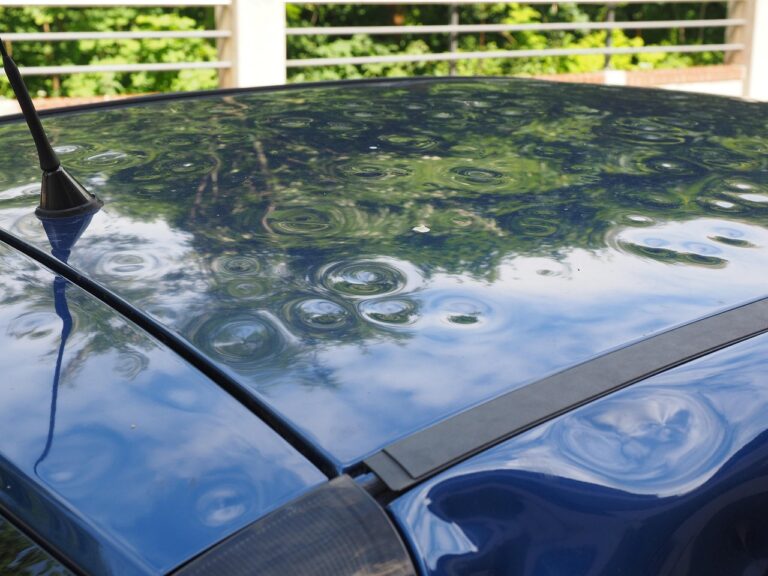 Hail damage car with dents after a storm, showing how severe weather impacts vehicle value.