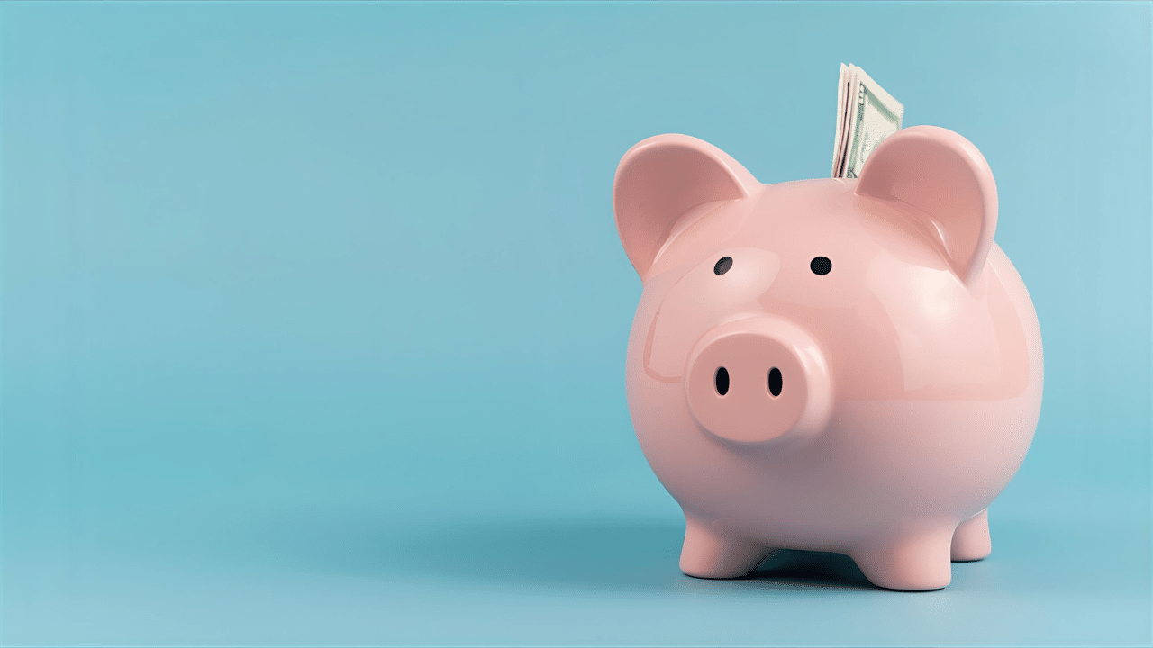 pink piggy bank with cash sticking out